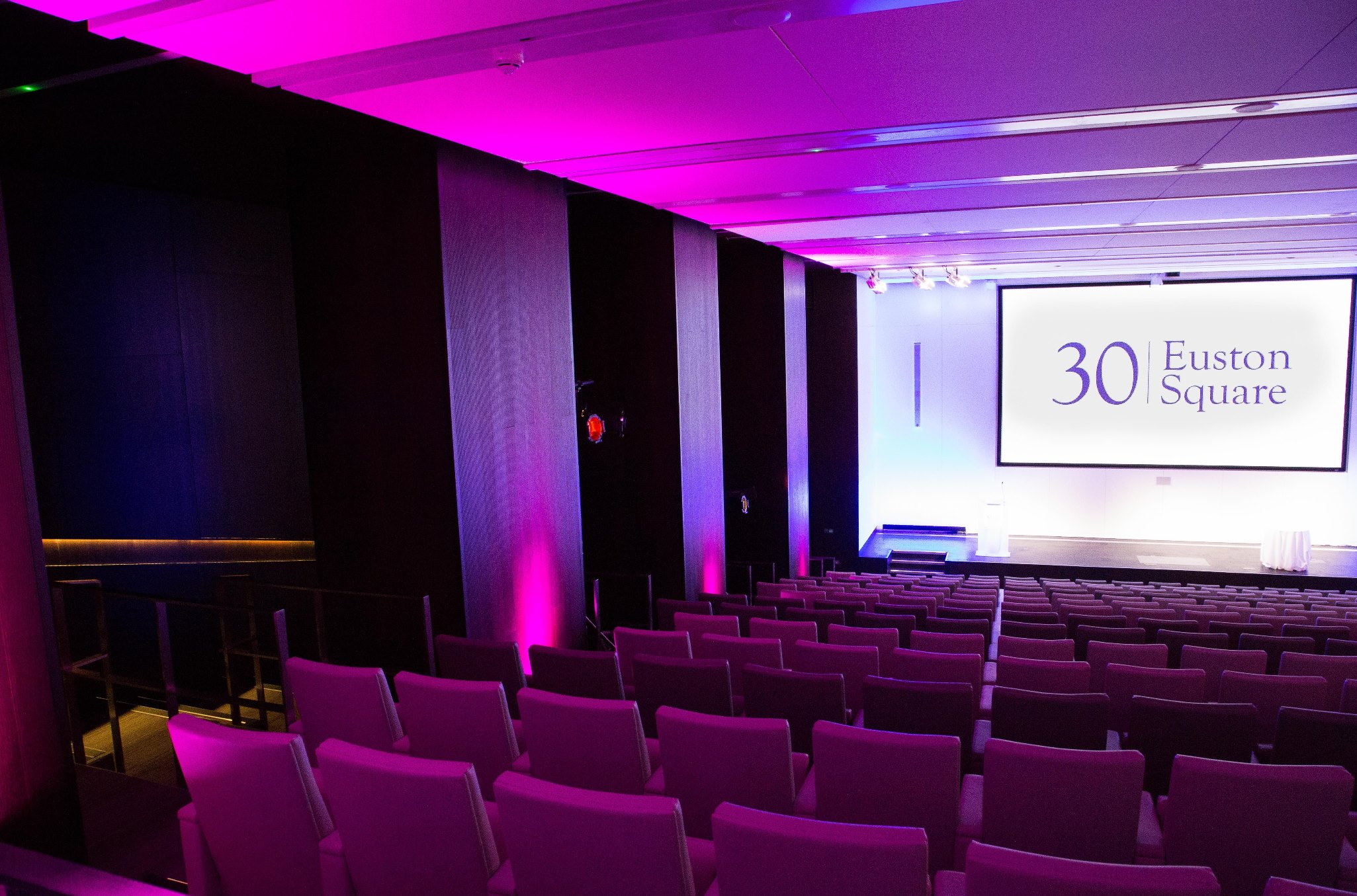 Auditorium pink lighting  in empty venue space